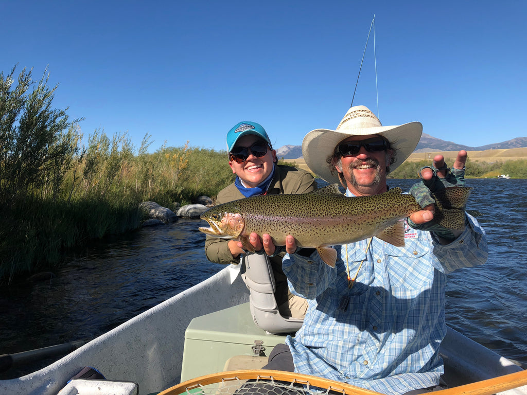 Guide and Outfitter Brian Rosenberg with a happy client and a beautiful rainbow trout from the Madison River near Ennis Montana